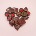 Load image into Gallery viewer, Goodio assorted chocolate pralines on a pink background