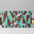 Lataa kuva gallerian katseluohjelmaan, Goodie Craft Chocolate's 'Magical Moments' gourmet chocolate bar set, featuring a geometric pattern of teal, brown, and pink triangles with gold lettering, shown on a white background.
