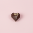 Load image into Gallery viewer, Goodio Sunshine in my heart chocolate candy with orange zest on a light pink background