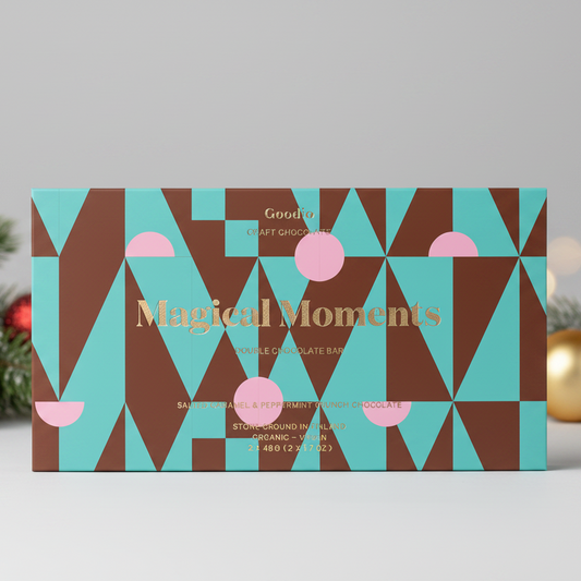Goodie Craft Chocolate's 'Magical Moments' gourmet chocolate bar set, featuring a geometric pattern of teal, brown, and pink triangles with gold lettering, shown on a white background.